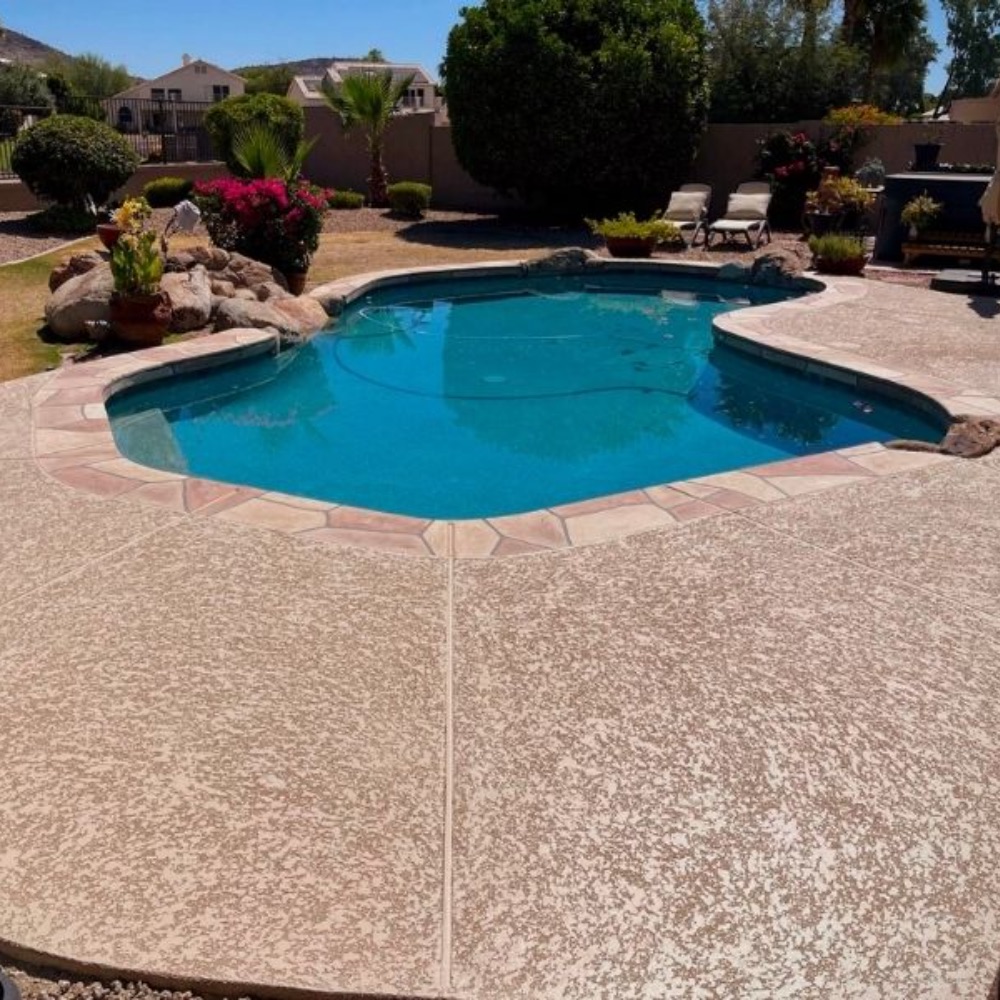 Stamped concrete pool deck coating on a community pool deck